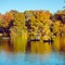 People salong on boats on the lake in New York City Central Park at autumn season time