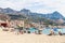 People on sand beach in Giardini Naxos town