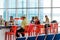 People seated at restaurant bar in an airport