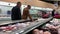 People selecting meat in grocery store