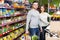 People shelves with canned goods