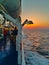 People on a ship deck travel to Aegean sea