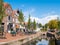 People shopping along canal in old town of Dokkum, Friesland, Netherlands