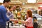 People shopping for food in the supermarket - checkout paying