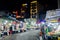 People shopping at traditional market in Vietnam. Night at crowded marketplace with street vendors. January, 2021