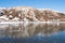 People on the shore of a frozen lake