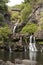 People showering under waterfalls