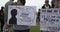 People with signs protesting vaccine mandates at Worldwide Freedom Rally