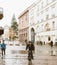 People silhouette with umbrella in front of in motion tramway on the almost