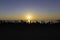 People silhouette watching sunset near Polente lighthouse at Bozcaada island