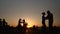 People silhouettes learning how to dance on quay at sunset - super slow motion