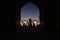 People silhouettes under the arch of mosque in Iran. September 12, 2016