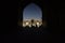 People silhouettes under the arch of mosque in Iran. September 12, 2016