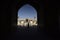 People silhouettes under the arch of mosque in Iran. September 12, 2016