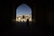 People silhouettes under the arch of mosque in Iran. September 12, 2016