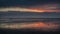 People silhouettes walking along the Wadden Sea in Buesum during dramatic sunset