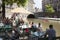 People sit and drink at outdoor cafe in city center of medieval utrecht in holland