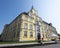 People sit in front of castle in german city of oldenburg on sunny summer day