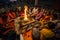 People sit near a ceremonial fire near Holy Ganges at night.
