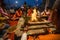 People sit near a ceremonial fire near the Holy Ganges at night.