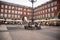People sit under a lamppost at Madrid`s Plaza Mayor