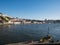 People sit on the waterfront on Douro River, Porto, Portugal