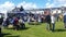 People sititng at picnic benches at food festival