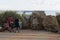 People sitting on a bench beside the stone bears at the Safari Park in Gelendzhik, Krasnodar region, Russia