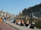 People sitting by a canal for Queens Day celebrations in Amsterdam