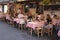 People sitting at the exterior tables of a Roman trattoria