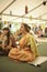 People sitting on the floor and listening to guru preaching during festival of Yoga and Vedic Culture Vedalife
