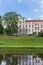 People sitting in the grass in front of the castle of Celle