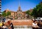 People are sitting near small fountain near Building of Old Hospital de Sant Paul in Barcelona, Spain