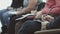 People sitting in a row of chairs and taking down a few notes during an orientation seminar.