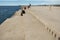 People sitting by Sea Organ, an architectural sound art located in Zadar, Croatia