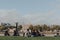 People sitting socially distanced by the river Thames, Tower of London on the background