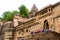 People sitting on stairs of Ahilya fort with the walls