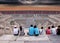 People sitting on stairs in forbidden city and looking at storms approaching