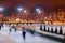 People skate in the evening in the Park in winter.