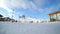 People skiing on mountain slopes in ski resort, unrecognizable skiers enjoying winter activity on snow.