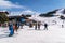 People skiing and snowboarding in Slopes of Grandvalira ski area of Pyrenees Mountains in Andorra