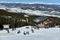 People skiing and snowboarding on snowy hill at Breckenridge Ski resort.