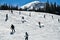 People skiing and snowboarding on snowy hill at Breckenridge Ski resort. Extreme winter sports.
