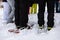 People with skis stand in a circle in the snow