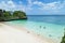 People snorkeling in clear turquoise water of a secluded tropical beach, Okinawa, Japan