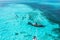 People snorkelling around the ship wreck near Bahamas in the Caribbean sea.