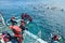 People snorkelling and dive from a platform in the Great Barrier