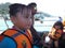 People in a speedboat trip in to a tropical island.