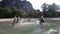 People Splashing In Water, Cheerful Young Man And Woman Group Having Fun On Beach In Mountains