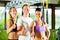 People in sport gym on suspension trainer